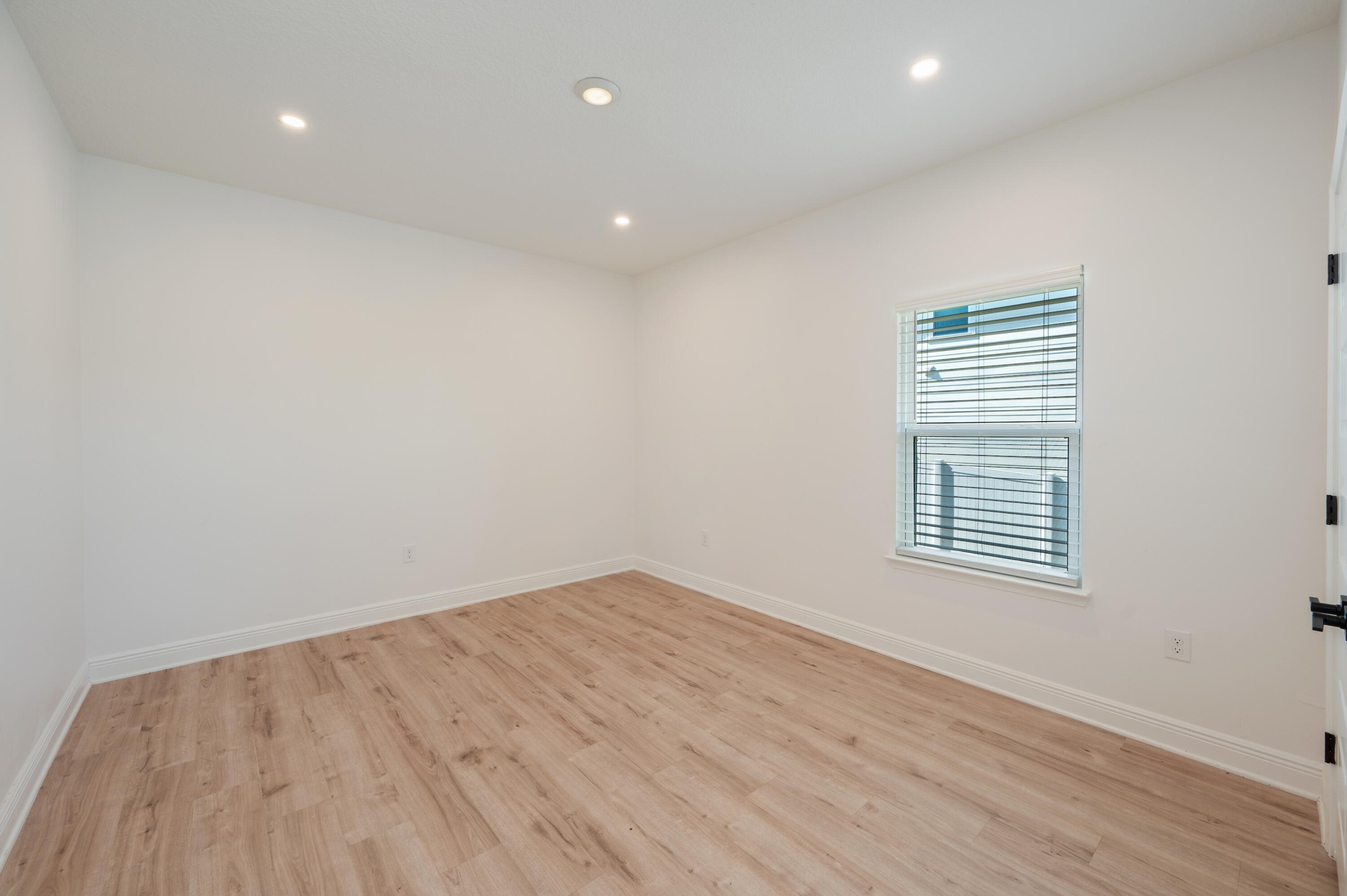 53 Palmer Lane Santa Rosa Beach, FL 32459 - Photo 34 of 62 a view of an empty room with wooden floor and a window