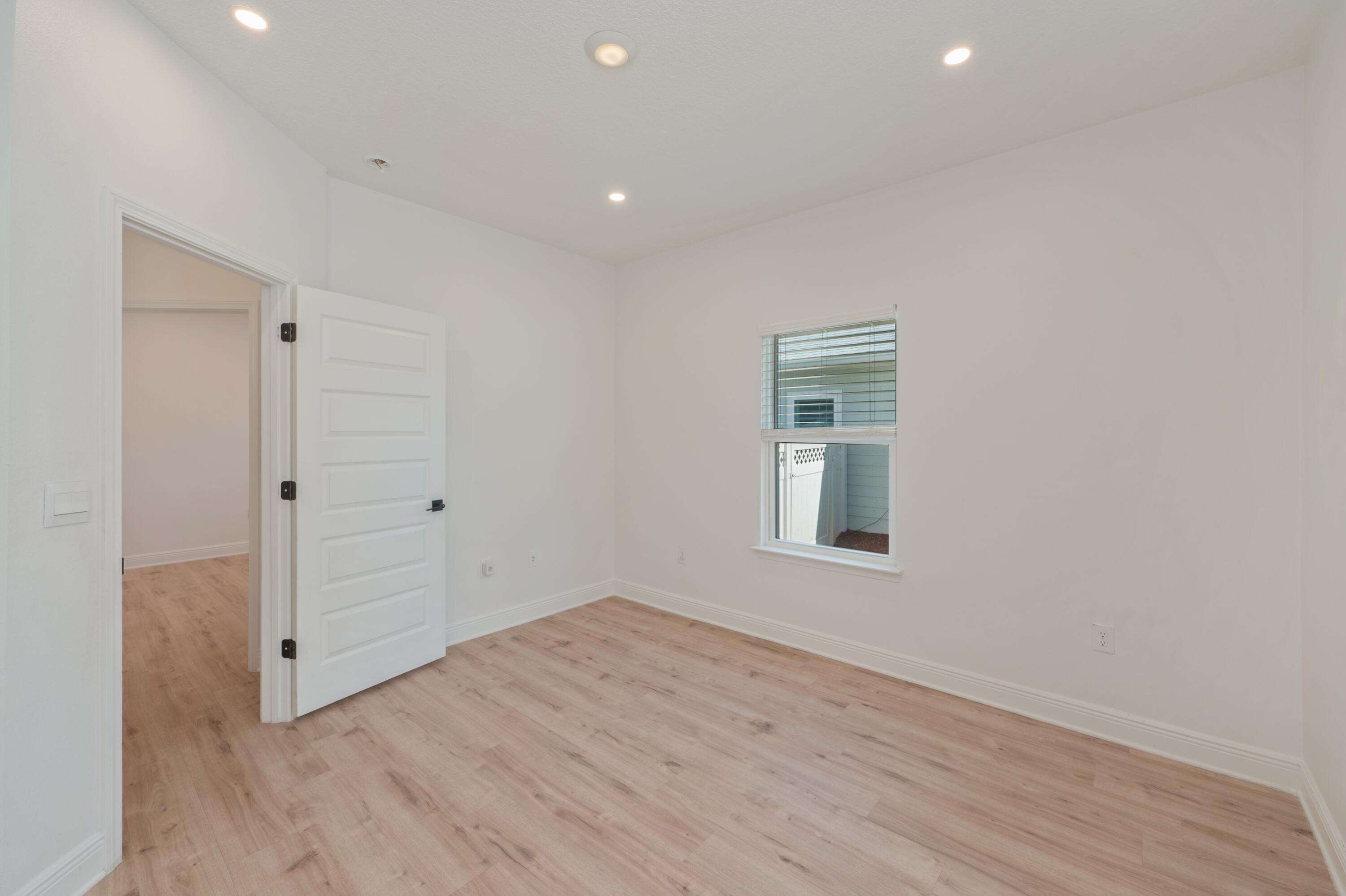 53 Palmer Lane Santa Rosa Beach, FL 32459 - Photo 41 of 62 wooden floor in an empty room with a window