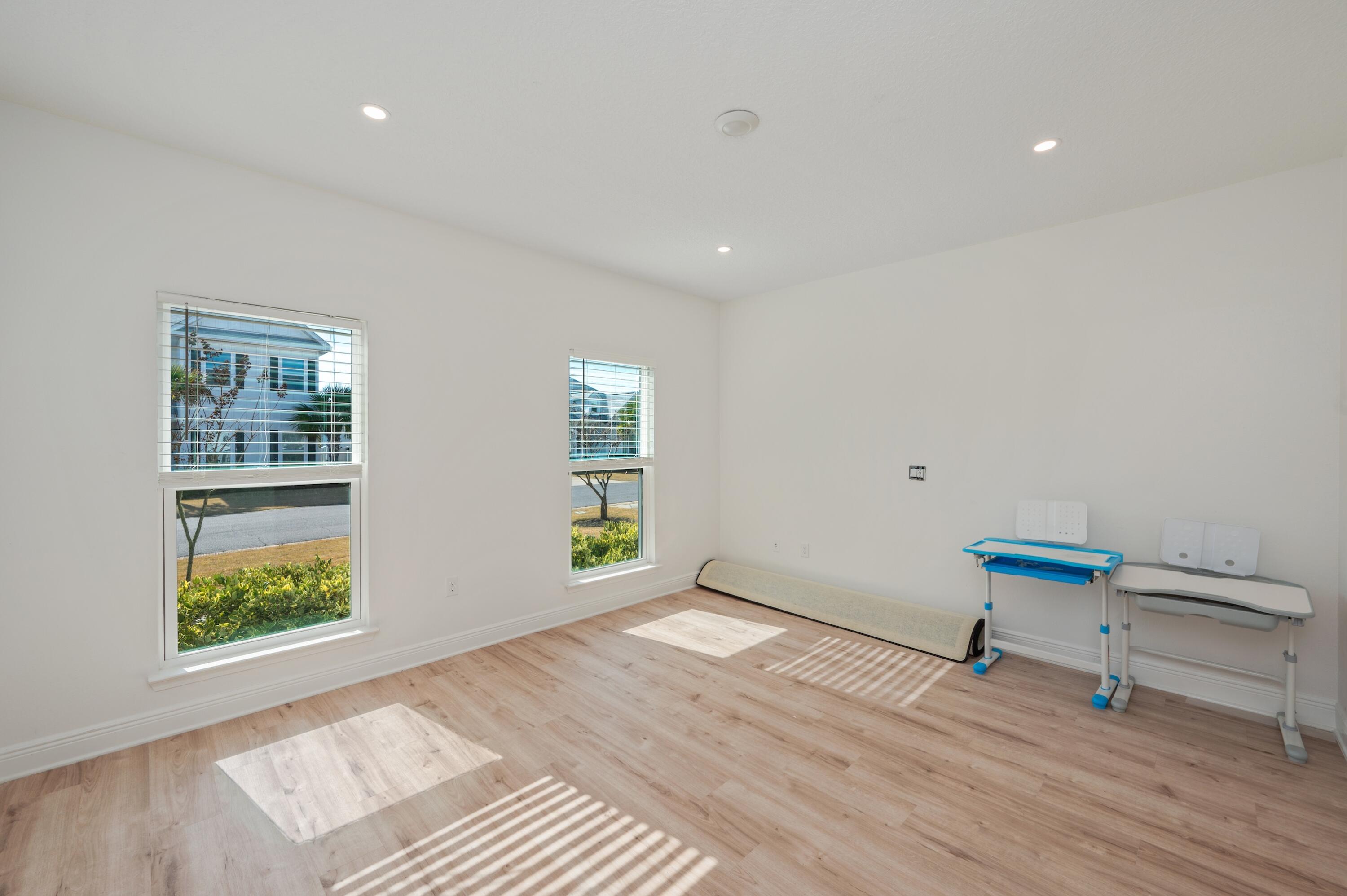 53 Palmer Lane Santa Rosa Beach, FL 32459 - Photo 43 of 62 wooden floor in an empty room with a window