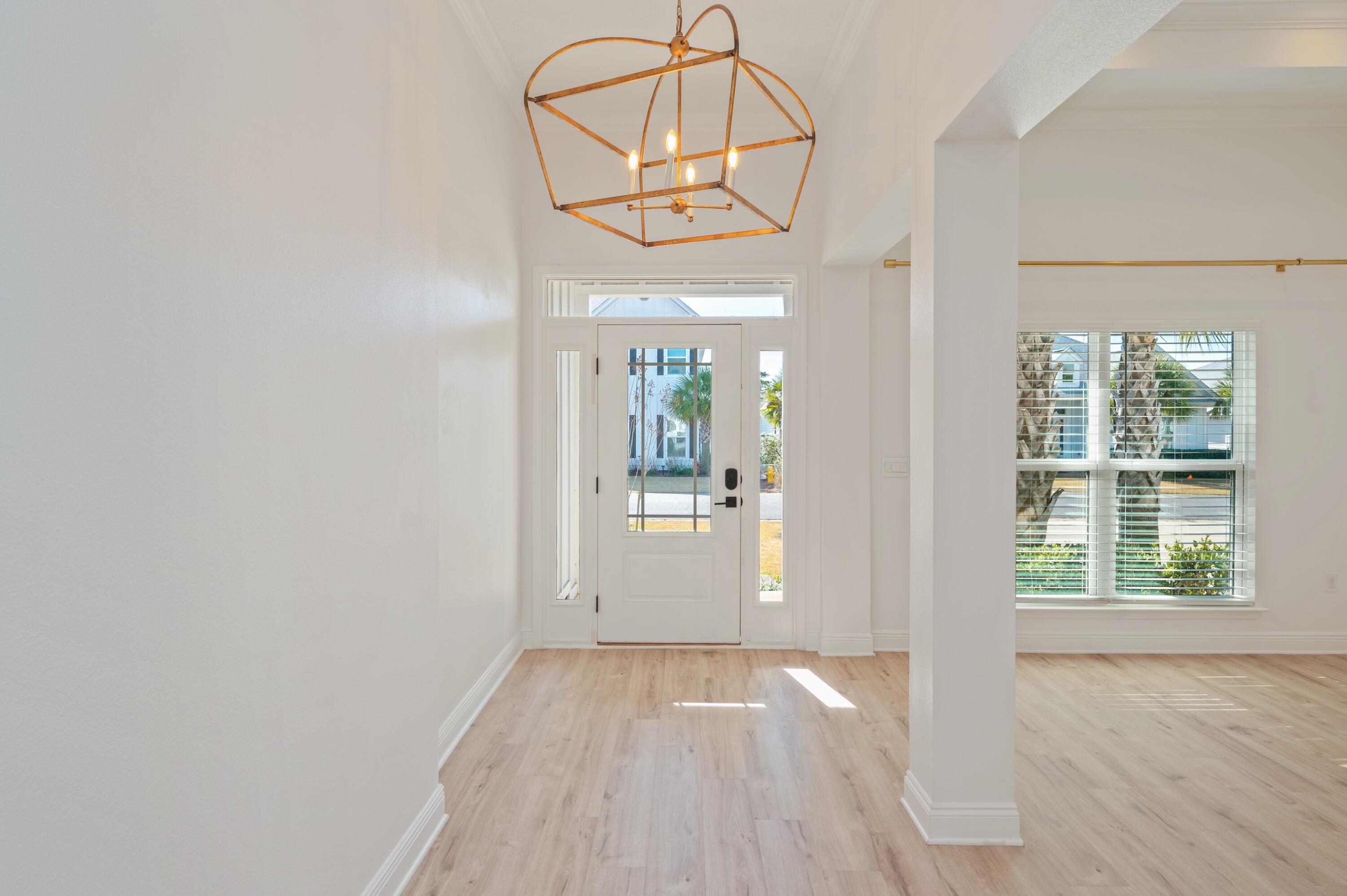 53 Palmer Lane Santa Rosa Beach, FL 32459 - Photo 6 of 62 an empty room with wooden floor cabinet and windows