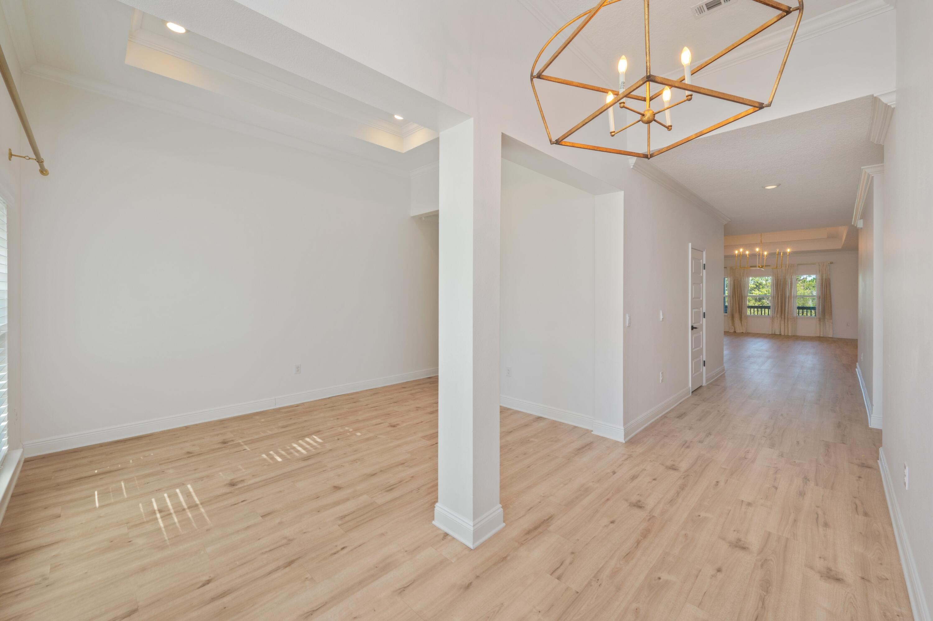 53 Palmer Lane Santa Rosa Beach, FL 32459 - Photo 7 of 62 an empty room with wooden floor and hallway