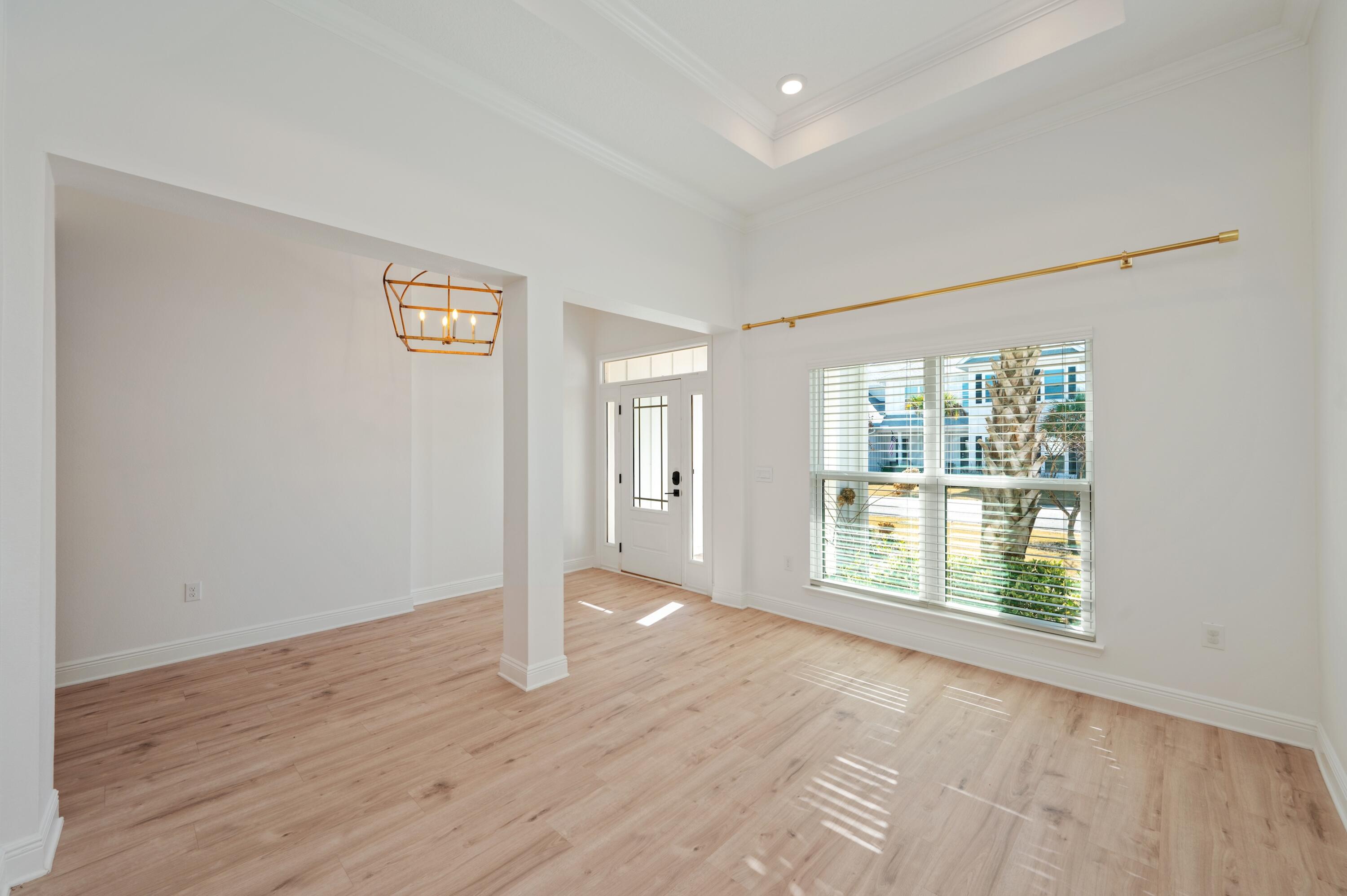 53 Palmer Lane Santa Rosa Beach, FL 32459 - Photo 8 of 62 a view of an empty room with wooden floor and a window