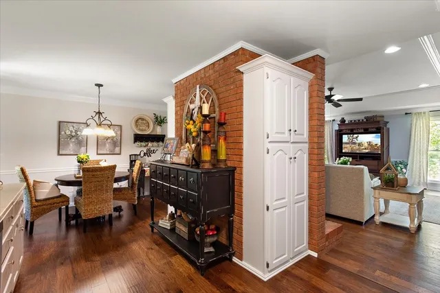 a living room with furniture a flat screen tv and kitchen view