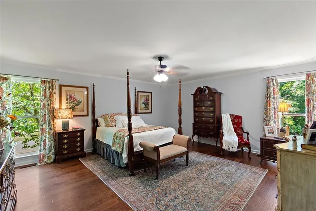a bedroom with a large bed and a chandelier