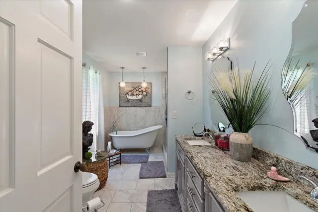 a bathroom with a sink mirror and vanity