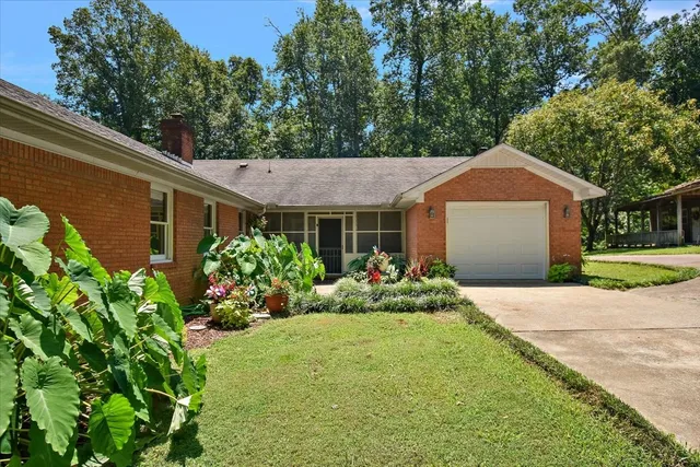 a view of a green field with wooden fence