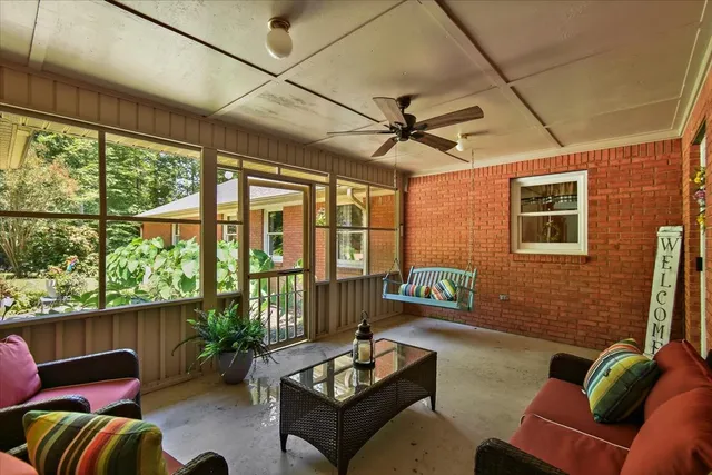 a view of a house with a big yard plants and large trees