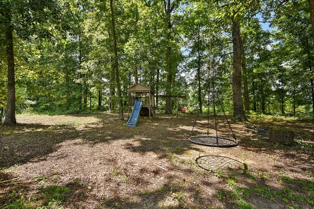 a view of a yard with swimming pool