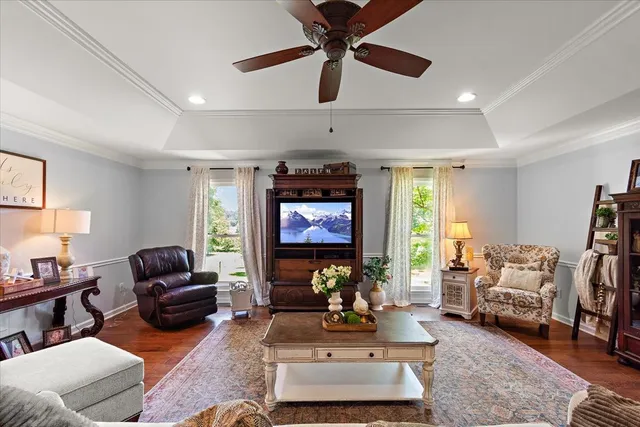 a living room with furniture a window and a flat screen tv