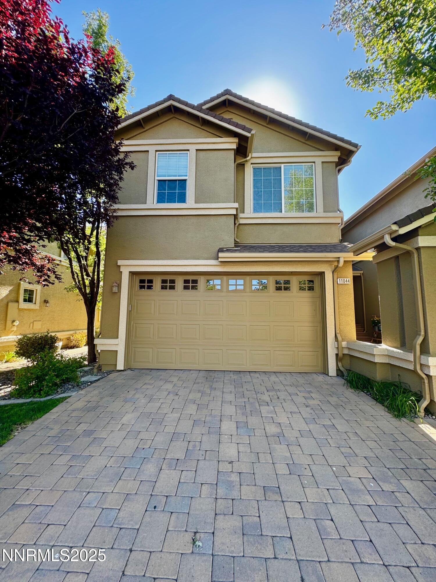 11044 Lamour Lane Reno, NV 89521 - Photo 1 of 21 a front view of a house with a yard and garage