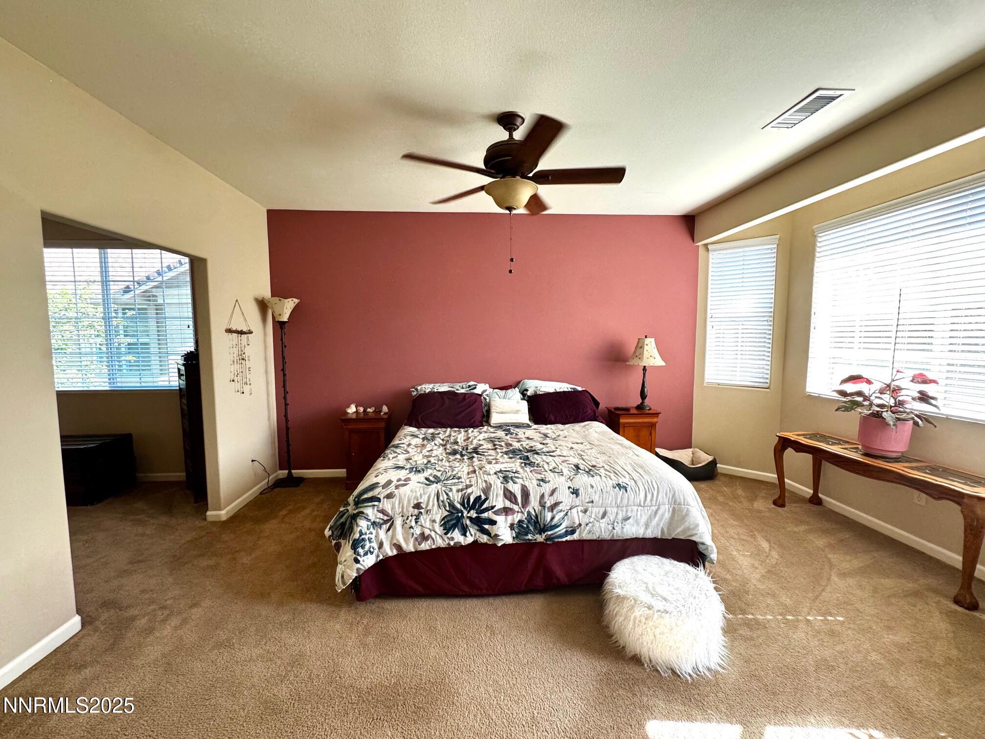 11044 Lamour Lane Reno, NV 89521 - Photo 11 of 21 a bedroom with a bed and a chandelier