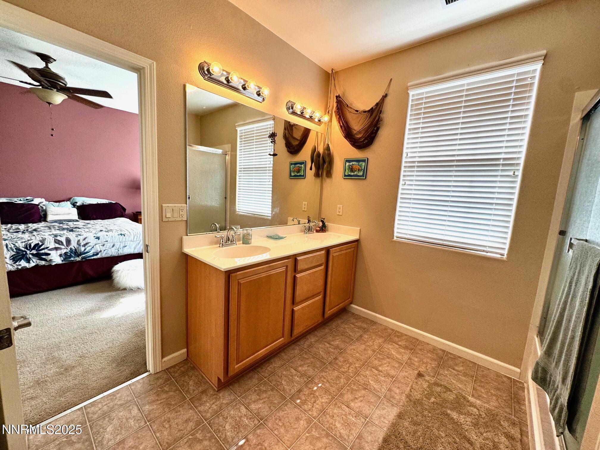 11044 Lamour Lane Reno, NV 89521 - Photo 12 of 21 a en suite bathroom with a sink and a mirror