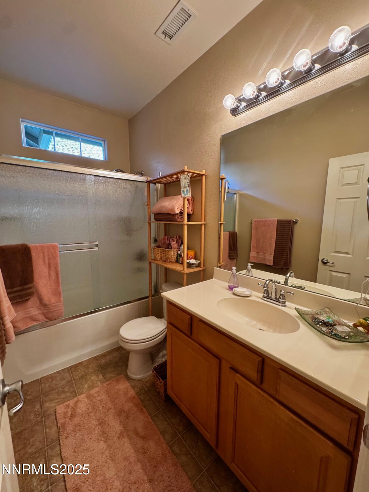 11044 Lamour Lane Reno, NV 89521 - Photo 17 of 21 a bathroom with a sink a toilet and shower