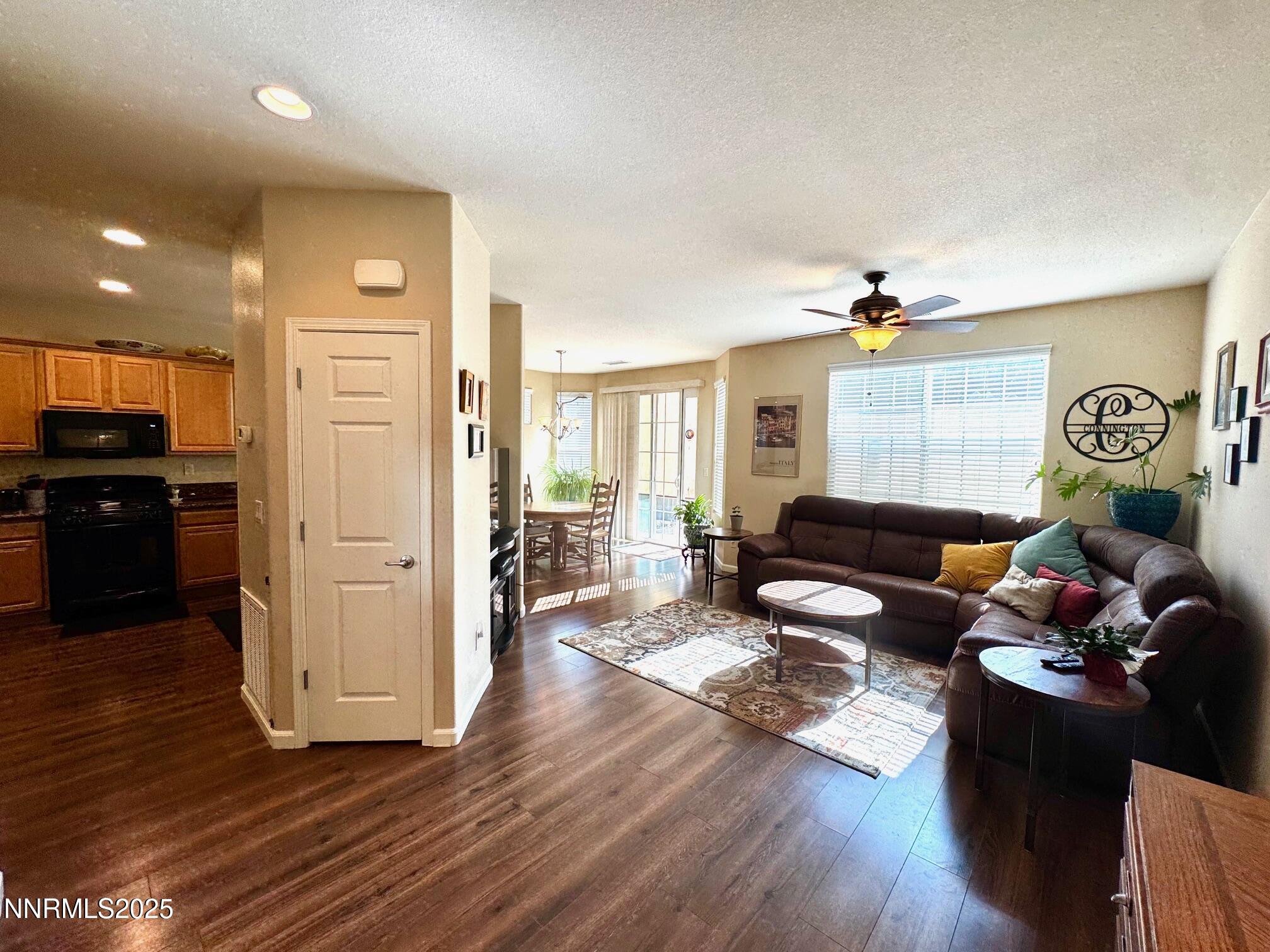 11044 Lamour Lane Reno, NV 89521 - Photo 3 of 21 a living room with furniture and a wooden floor