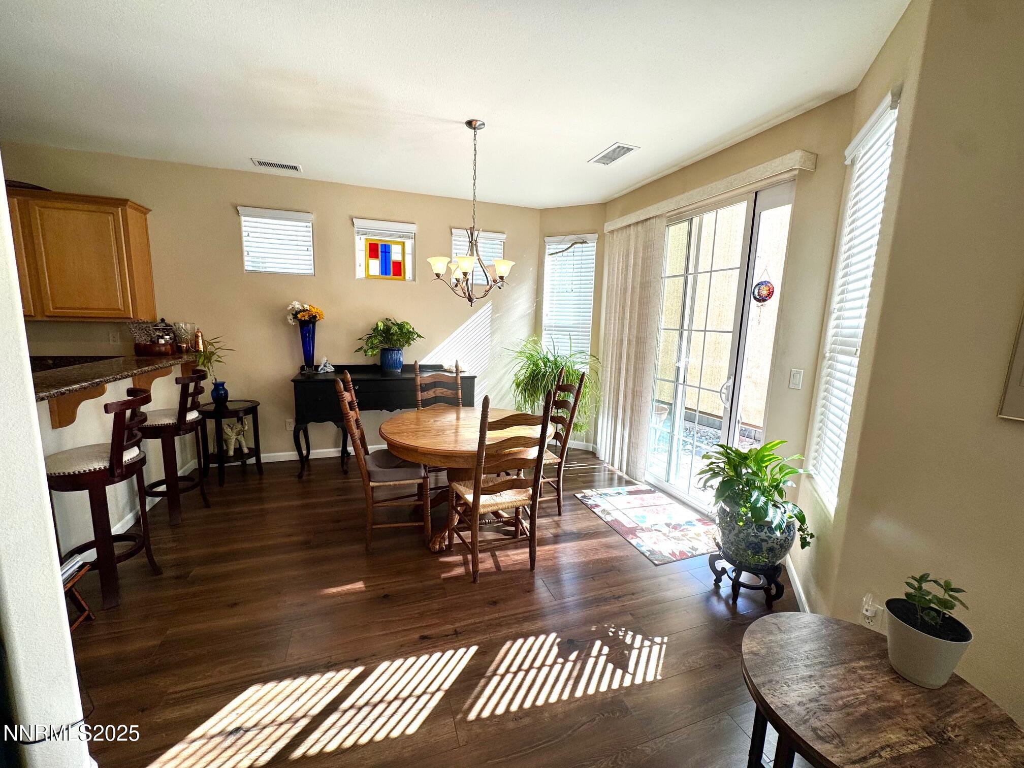 11044 Lamour Lane Reno, NV 89521 - Photo 4 of 21 a living room with furniture a dining table and a potted plant