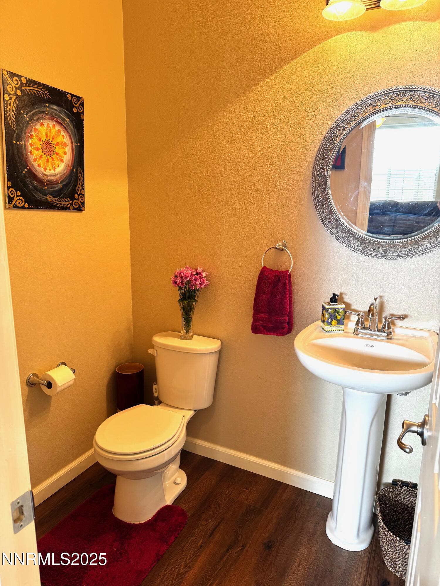 11044 Lamour Lane Reno, NV 89521 - Photo 8 of 21 a bathroom with a toilet a sink and a mirror