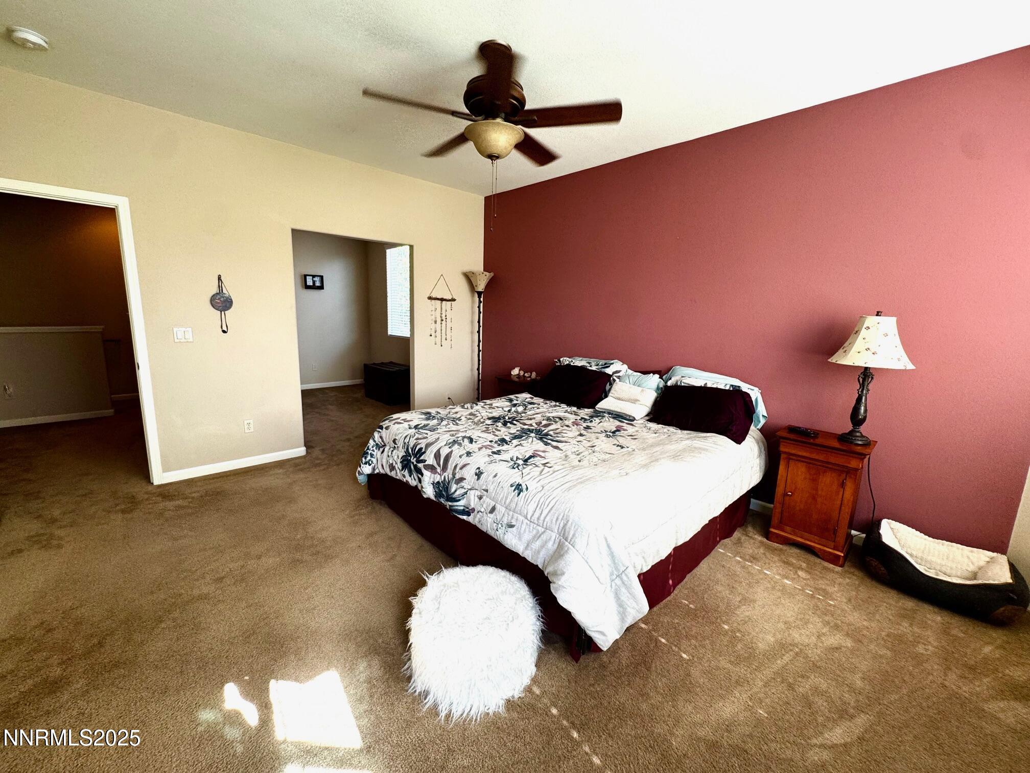 11044 Lamour Lane Reno, NV 89521 - Photo 10 of 21 a bedroom with a bed and a chandelier