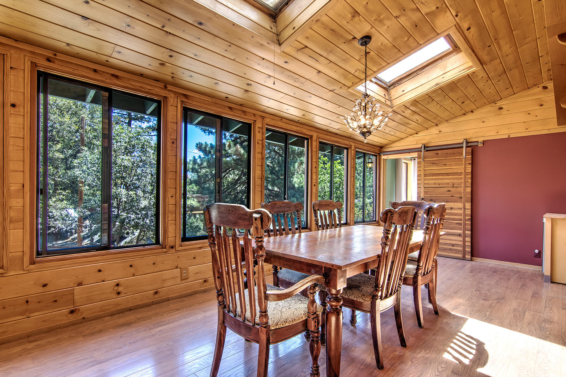 52890 Overlook Drive Idyllwild, CA 92549 - Photo 29 of 82 a view of a dining room with furniture large windows and wooden floor