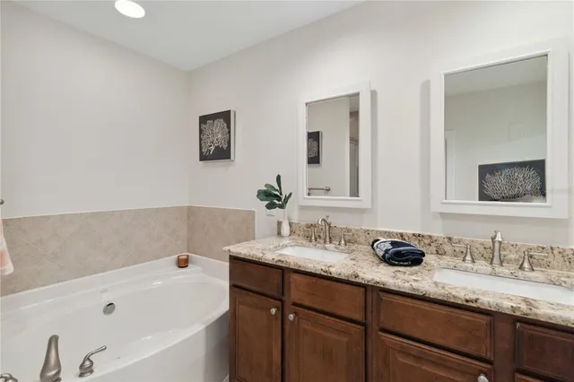 a bedroom with a bed a table and painting on the wall