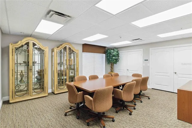 a front view of a building with a garden and plants