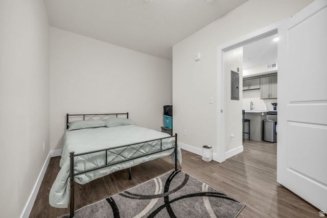 2101 North Main Street, Unit 409 Sunset, UT 84015 - Photo 9 of 18 Bedroom with dark wood-style floors and electric panel