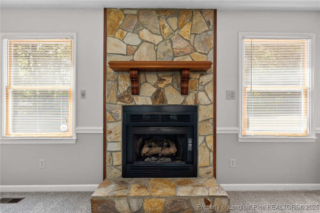 3560 School Road Fayetteville, NC 28306 - Photo 16 of 50 a living room with a fireplace and a window