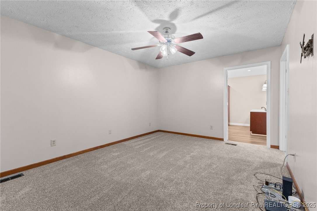 3560 School Road Fayetteville, NC 28306 - Photo 22 of 50 an empty room with windows and fan
