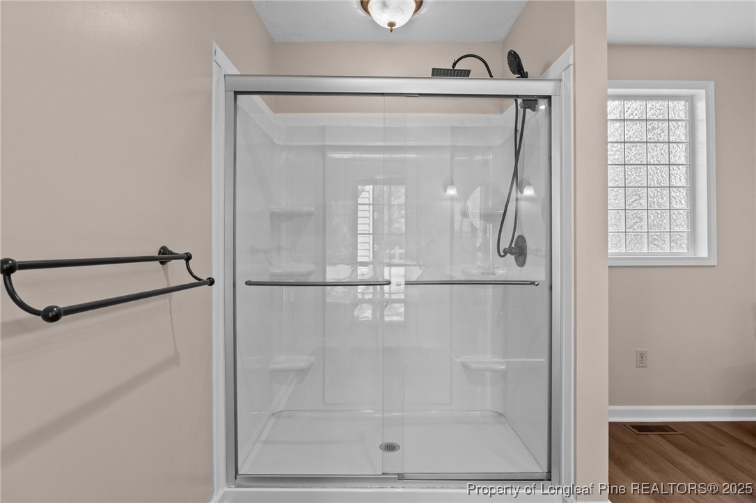 3560 School Road Fayetteville, NC 28306 - Photo 26 of 50 a bathroom with a glass shower door