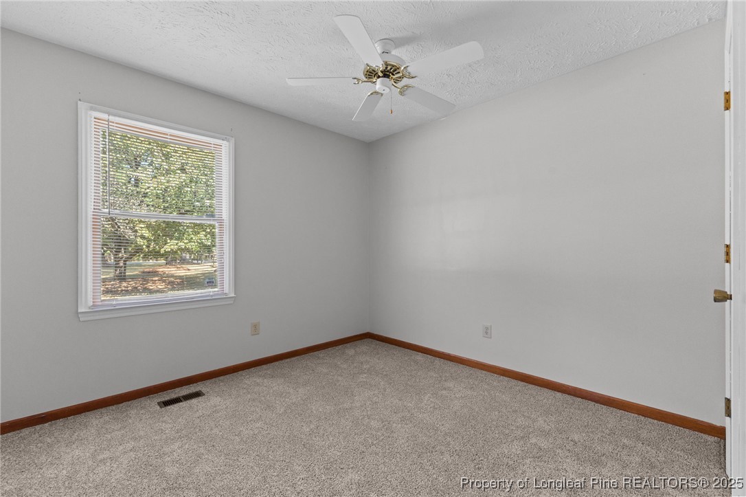 3560 School Road Fayetteville, NC 28306 - Photo 28 of 50 an empty room with a window and a fan