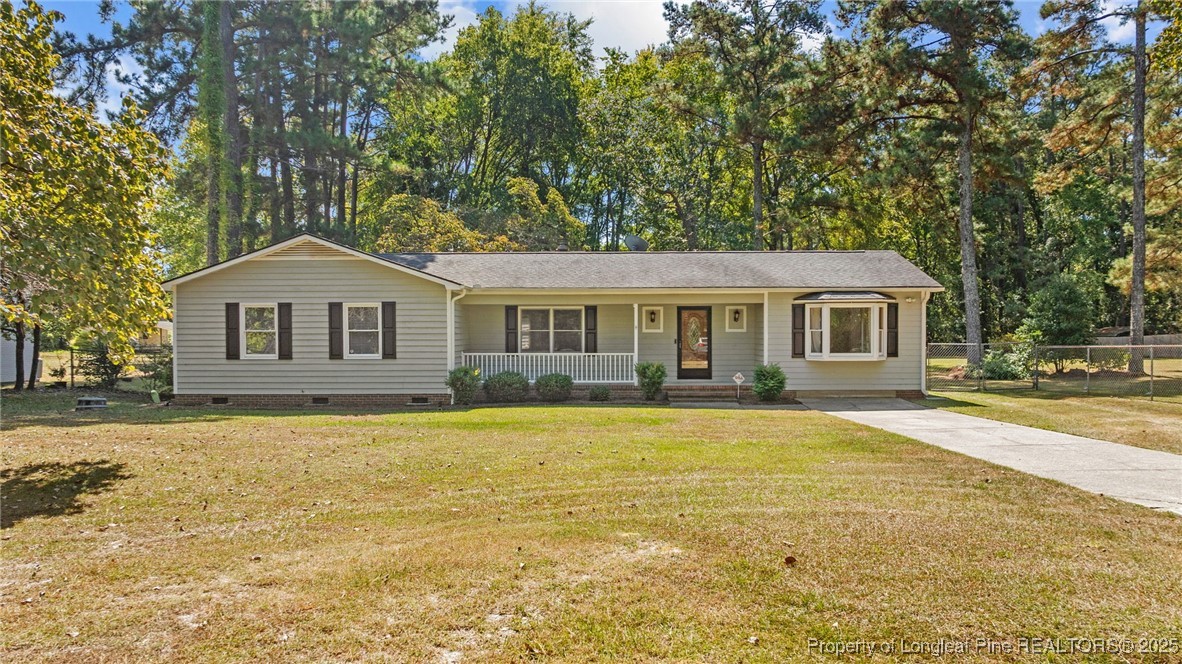 3560 School Road Fayetteville, NC 28306 - Photo 3 of 50 a front view of a house with a yard and garage