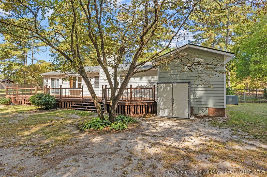3560 School Road Fayetteville, NC 28306 - Photo 48 of 50 a front view of a house with a garden and trees