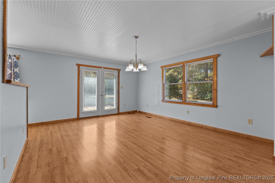 3560 School Road Fayetteville, NC 28306 - Photo 7 of 50 an empty room with wooden floor chandelier and windows
