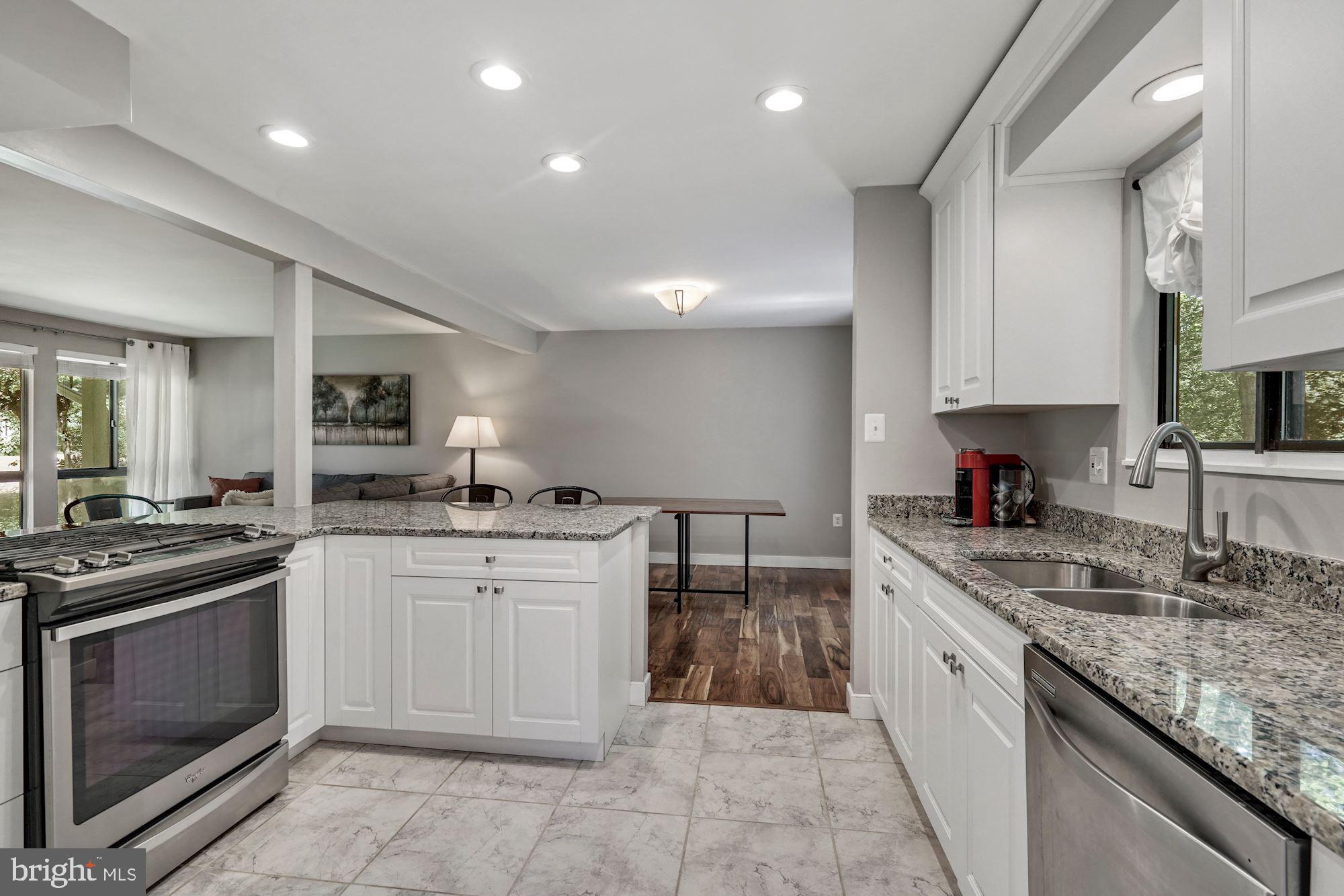 2119 Thomas View Road Reston, VA 20191 - Photo 11 of 41 a kitchen with granite countertop a sink stove top oven and cabinets