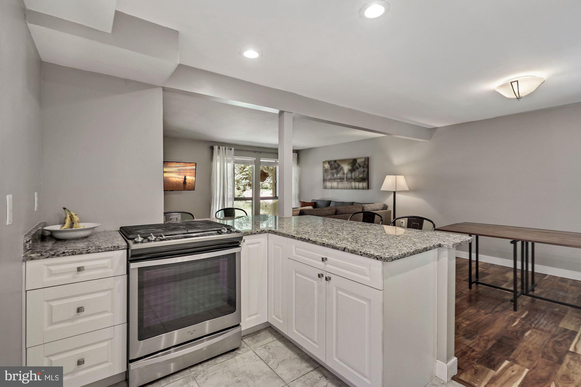 2119 Thomas View Road Reston, VA 20191 - Photo 12 of 41 a kitchen with granite countertop a stove oven and sink