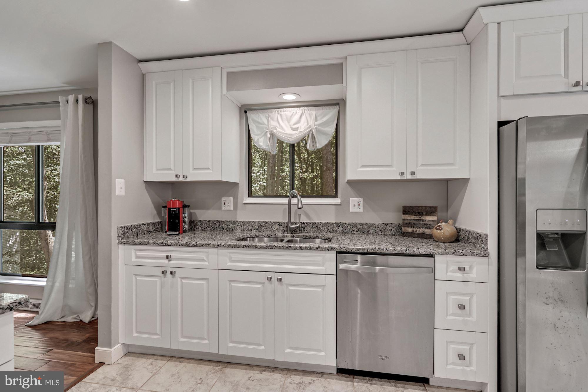 2119 Thomas View Road Reston, VA 20191 - Photo 13 of 41 a kitchen with granite countertop a sink stainless steel appliances and cabinets