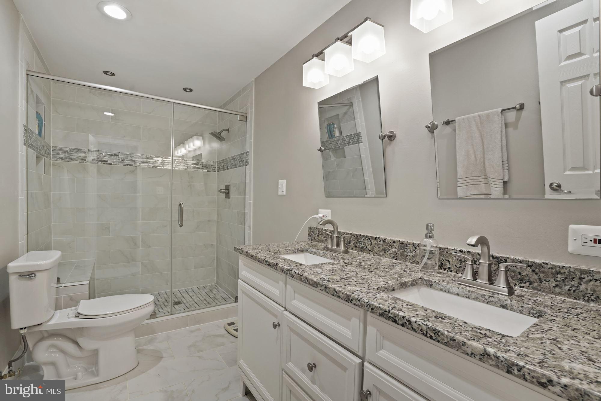 2119 Thomas View Road Reston, VA 20191 - Photo 24 of 41 a bathroom with a granite countertop sink toilet a mirror and shower