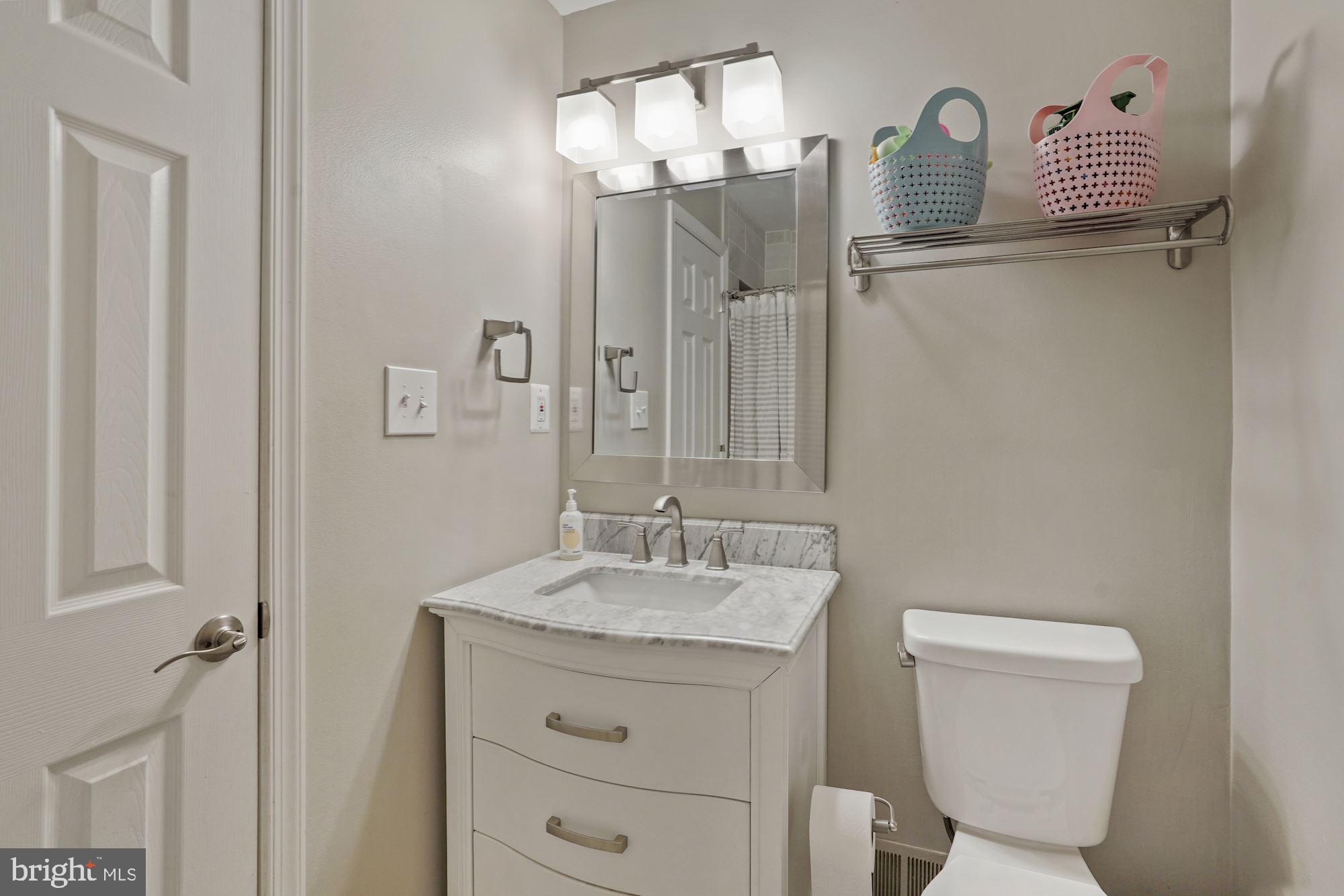 2119 Thomas View Road Reston, VA 20191 - Photo 29 of 41 a bathroom with a granite countertop sink mirror vanity and toilet