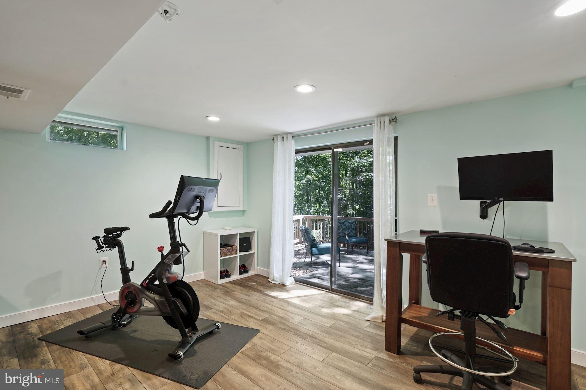 2119 Thomas View Road Reston, VA 20191 - Photo 35 of 41 a view of a workspace with furniture and a flat screen tv