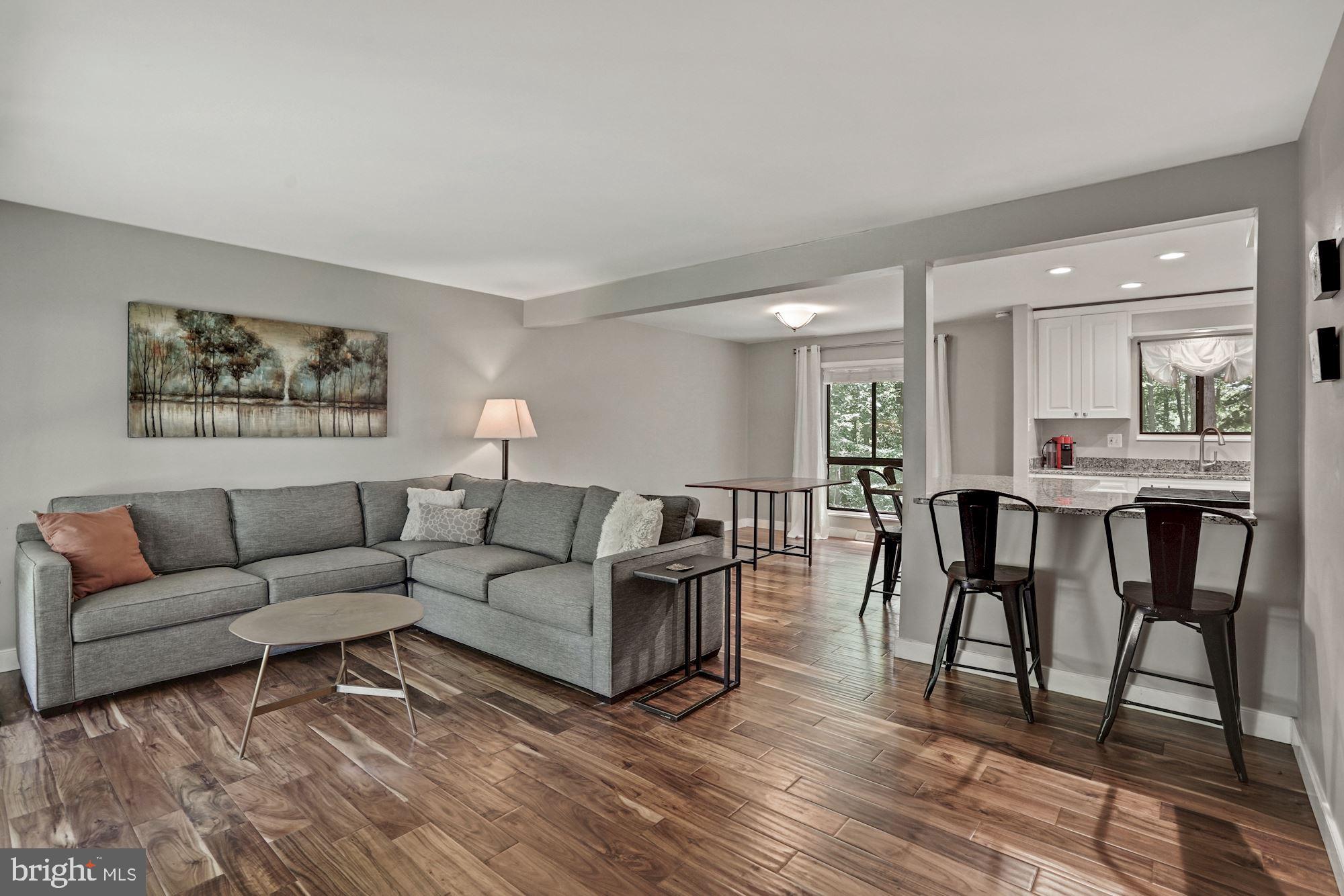 2119 Thomas View Road Reston, VA 20191 - Photo 5 of 41 a living room with furniture a wooden floor and a kitchen view