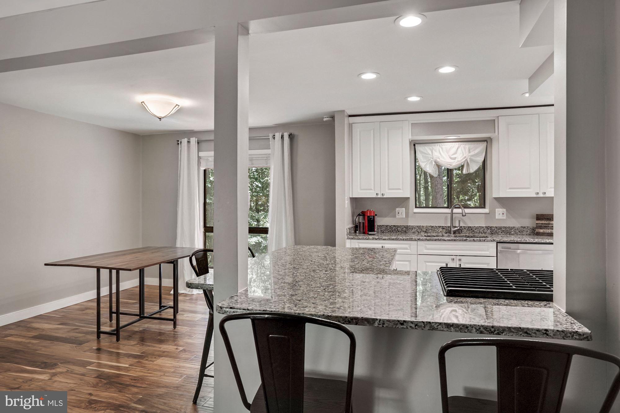 2119 Thomas View Road Reston, VA 20191 - Photo 9 of 41 a kitchen with counter space dining table and chairs