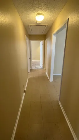 a view of an empty room with closet