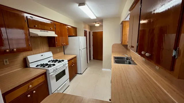 a kitchen with a stove and a refrigerator