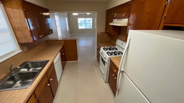 a view of an empty room with closet and a window