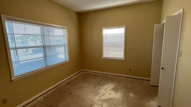 a view of hallway with an empty space and a window