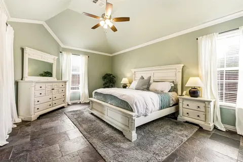 a bedroom with a bed and a television