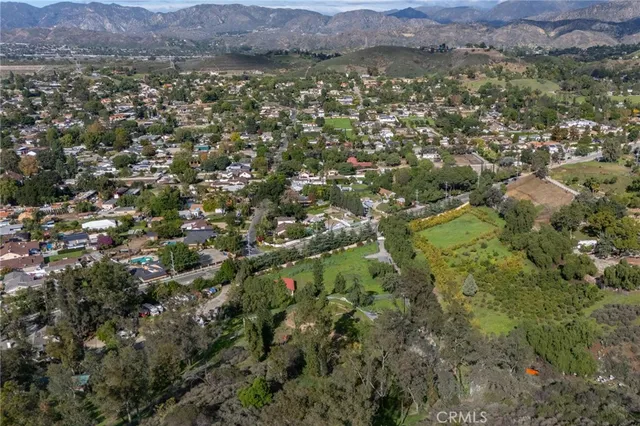 a view of a lush green hillside and a building in the background