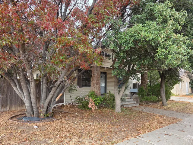 a view of a house with a tree