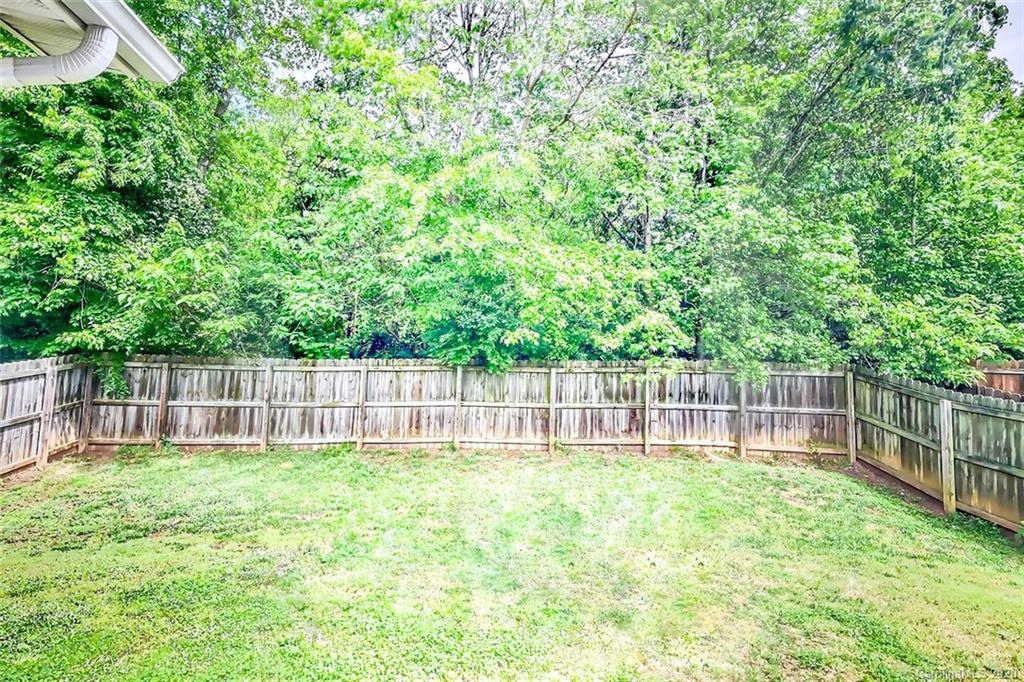 709 Jones Branch Road Fort Mill, SC 29715 - Photo 23 of 25 a view of a yard with a small cabin and wooden fence
