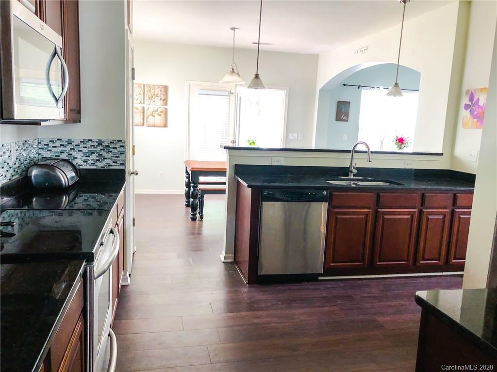 709 Jones Branch Road Fort Mill, SC 29715 - Photo 10 of 25 a kitchen with stainless steel appliances granite countertop a stove a sink and a wooden cabinets