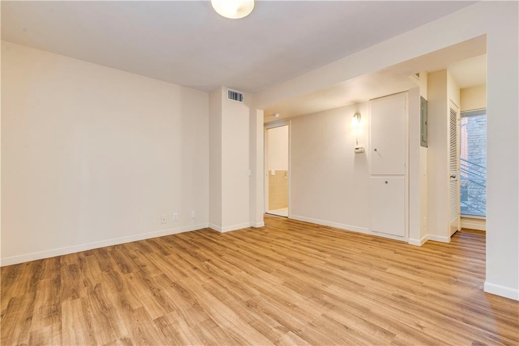 2800 Cole Street, Unit 107C Austin, TX 78705 - Photo 7 of 13 a view of an empty room and wooden floor